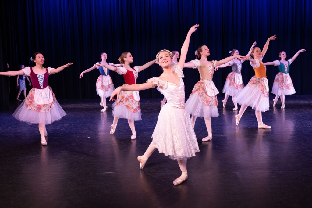 group of ballet dancers on stage