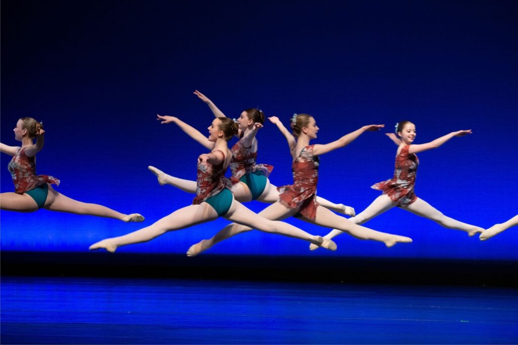 girls performing ballet on stage together