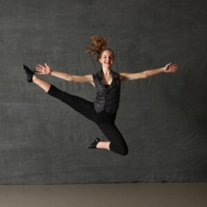 a teen girl jumping in air for picture