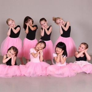 little girls in pick tutus posing for a picture
