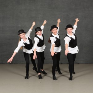 little kids tapping in costume on stage