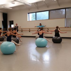 girls on exercise balls in ballet clothes