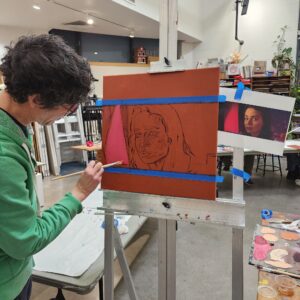 artist working on the early stages of a portrait