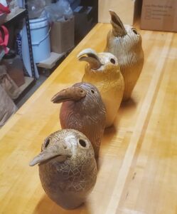 four kiwi bird shaped ceramic vessels