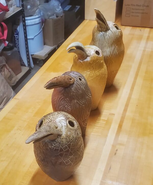 four kiwi bird shaped ceramic vessels