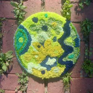 a round rug with an abstract green design