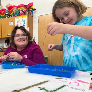 kids working on art projects and smiling