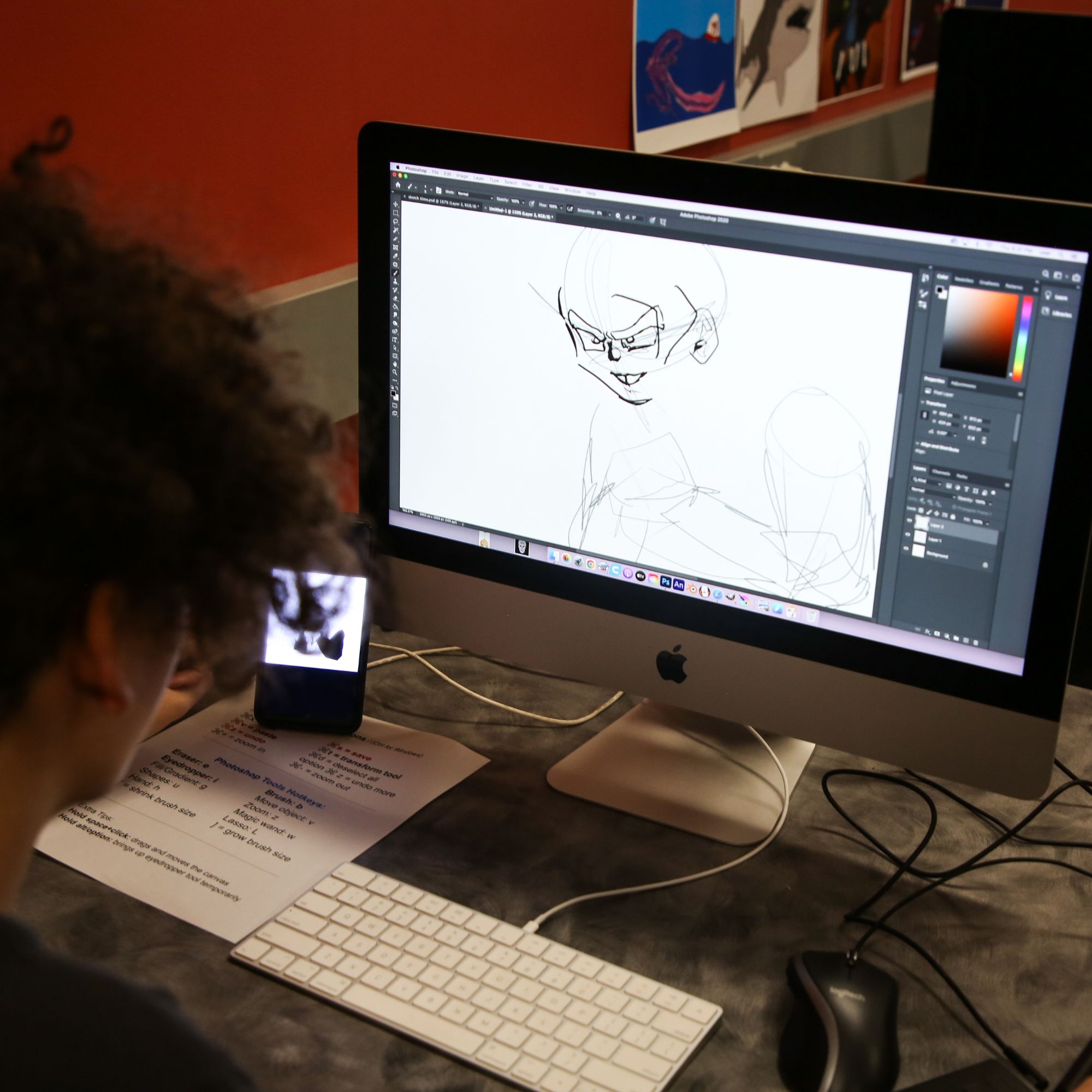 student drawing a character on the computer