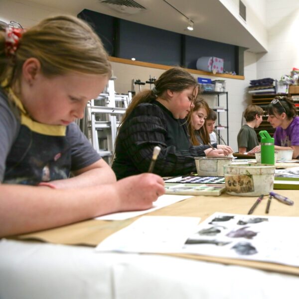 a class of students painting