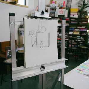 A pencil sketch of geometric forms on an easel