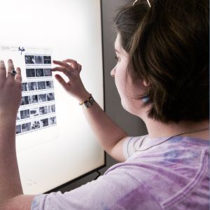 Student looking at developed film using a backlight